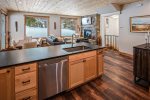 Inviting kitchen with plenty of workspace and forested views. 